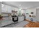 Charming kitchen offers stainless appliances, granite counters, and ample natural light at 1052 Hughes Trl, Elon, NC 27244