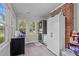 Functional laundry room featuring modern washer and dryer, storage cabinets, and natural light at 1052 Hughes Trl, Elon, NC 27244