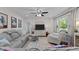 Bright living room with large window, ceiling fan, and comfortable seating area at 1052 Hughes Trl, Elon, NC 27244