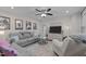 Bright living room with large window, ceiling fan, and comfortable seating area at 1052 Hughes Trl, Elon, NC 27244