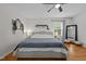 Serene main bedroom features a ceiling fan, hardwood floors, and neutral decor at 1052 Hughes Trl, Elon, NC 27244