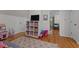 Bright playroom with hardwood floors, toy storage, and a cozy seating area at 1052 Hughes Trl, Elon, NC 27244