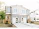 Modern duplex with two-story design, gray siding, and white garage doors, offering appealing curb appeal at 107 S Plum St, Durham, NC 27703