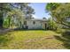 View of home's fenced backyard surrounded by mature trees at 1109 N Pinkston St. St, Henderson, NC 27536