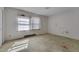 Bedroom with damaged walls, dated carpet, and natural light through two windows at 1109 N Pinkston St. St, Henderson, NC 27536