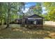 Backyard view of the house, sunroom, and yard at 1115 Chestnut Dr, Smithfield, NC 27577