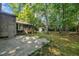 Enjoy the tree-lined backyard with patio, storage shed, and lush greenery at 1115 Chestnut Dr, Smithfield, NC 27577