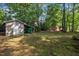 A storage shed is located on the tree-filled backyard at 1115 Chestnut Dr, Smithfield, NC 27577