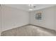 A carpeted bedroom features wallpaper and a window view of the outside at 1115 Chestnut Dr, Smithfield, NC 27577