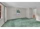 Bright bedroom with fresh paint, lush green carpet, and a charming window view of the yard at 1115 Chestnut Dr, Smithfield, NC 27577