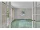 A bright bedroom with french doors, light-colored walls and green carpeting at 1115 Chestnut Dr, Smithfield, NC 27577