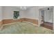 The dining room features a chandelier, green carpet and an open doorway at 1115 Chestnut Dr, Smithfield, NC 27577
