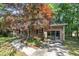 Charming brick home with a well-manicured lawn, mature trees and covered front porch at 1115 Chestnut Dr, Smithfield, NC 27577