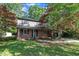 Traditional-style home with brick facade, a covered front porch and lush front yard at 1115 Chestnut Dr, Smithfield, NC 27577