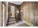The foyer features dark wood paneling, a staircase to the left and a wood door to the right at 1115 Chestnut Dr, Smithfield, NC 27577