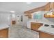 This kitchen has light wood-stained cabinets, white countertops and modern appliances at 1115 Chestnut Dr, Smithfield, NC 27577