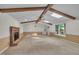 Open living room features wood beams, skylights, fireplace, and natural light at 1115 Chestnut Dr, Smithfield, NC 27577