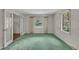 Cozy living room features bright windows, lush green carpet, and charming French doors at 1115 Chestnut Dr, Smithfield, NC 27577