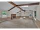 Open living room features wood beams, skylights, fireplace, and natural light at 1115 Chestnut Dr, Smithfield, NC 27577