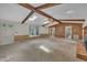 Expansive living room features brick accent wall, fireplace, wood beams, and skylights at 1115 Chestnut Dr, Smithfield, NC 27577