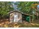 A detached storage shed is located on the tree-filled property at 1115 Chestnut Dr, Smithfield, NC 27577