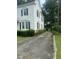 Long driveway leading to a detached two-car garage, offering ample parking space and privacy at 112 E Sycamore St, Zebulon, NC 27597