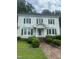 Inviting two-story home with classic architectural details and a brick pathway leading to the entrance at 112 E Sycamore St, Zebulon, NC 27597