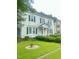 Charming two-story home with a well-manicured front yard featuring green lawn and mature bushes at 112 E Sycamore St, Zebulon, NC 27597