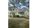 Back of home features a ramp and large yard, providing easy accessibility and outdoor space at 112 E Sycamore St, Zebulon, NC 27597