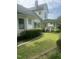 Green and landscaped yard showcasing the side and rear of the home, with manicured bushes at 112 E Sycamore St, Zebulon, NC 27597