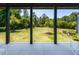 Covered patio provides views of the manicured backyard lawn and mature trees at 115 Founders Ridge Dr, Chapel Hill, NC 27517