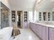 Elegant bathroom with a soaking tub, marble counters, lavender cabinetry, and walk in closet at 115 Founders Ridge Dr, Chapel Hill, NC 27517