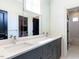 Bathroom with dual sink vanity, neutral countertops and access to the bedroom and shower/toilet room at 115 Founders Ridge Dr, Chapel Hill, NC 27517