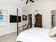 Spacious bedroom featuring a black four-poster bed frame, flatscreen television, and light walls at 115 Founders Ridge Dr, Chapel Hill, NC 27517