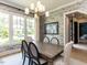 Bright dining room with a large window, stylish wallpaper, and seating for six, perfect for Gathering meals at 115 Founders Ridge Dr, Chapel Hill, NC 27517