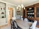 Well-appointed dining room featuring a large wooden table, chandelier, and decorative wallpaper, ideal for gatherings at 115 Founders Ridge Dr, Chapel Hill, NC 27517