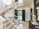 Inviting foyer showcasing a grand staircase, beautiful floors, and black double-doors at 115 Founders Ridge Dr, Chapel Hill, NC 27517