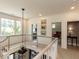 Light-filled hallway with hardwood floors and views into other rooms at 115 Founders Ridge Dr, Chapel Hill, NC 27517