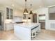 Gourmet eat-in kitchen with a large center island, hardwood floors, and stainless appliances at 115 Founders Ridge Dr, Chapel Hill, NC 27517