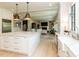 Eat-in kitchen view of island, counters, and staircase to the upper level at 115 Founders Ridge Dr, Chapel Hill, NC 27517