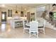 Kitchen with custom island and breakfast bar, leading to staircase at 115 Founders Ridge Dr, Chapel Hill, NC 27517