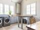 Well-lit laundry room with stainless steel appliances and a functional workspace at 115 Founders Ridge Dr, Chapel Hill, NC 27517
