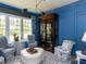 Comfortable sitting room with blue walls, a large cabinet, and plush seating, perfect for relaxation at 115 Founders Ridge Dr, Chapel Hill, NC 27517