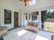 Relaxing sunroom with wicker furniture, ceiling fan, and access to the home's interior at 115 Founders Ridge Dr, Chapel Hill, NC 27517