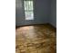Interior view of a bedroom with hardwood floors and a window at 116 Dunstan Ave, Durham, NC 27707