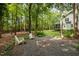 Fire pit with chairs provides a relaxing outdoor space, nestled in a lush, tree-filled backyard at 118 Cavendish Ct, Hillsborough, NC 27278