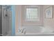 Bathroom showcasing a jacuzzi tub, glass block window and a shower at 118 Cavendish Ct, Hillsborough, NC 27278