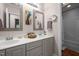 Bathroom featuring double vanity with framed mirrors, cabinet storage, and bathtub with white shower curtain at 118 Cavendish Ct, Hillsborough, NC 27278