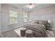 Neutral bedroom with plush bed, paneled accent wall, and natural light from large windows at 118 Cavendish Ct, Hillsborough, NC 27278