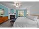 Bedroom with fireplace, blue accent wall, and king size bed at 118 Cavendish Ct, Hillsborough, NC 27278